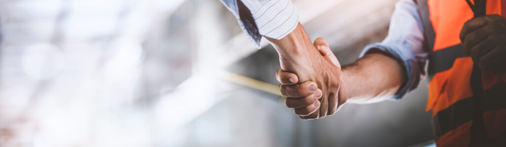 Two engineer shaking hands with deals and congratulations on suc